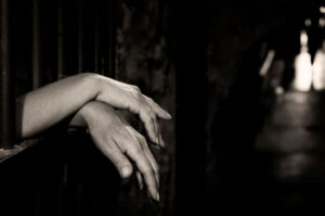 hands in jail cell