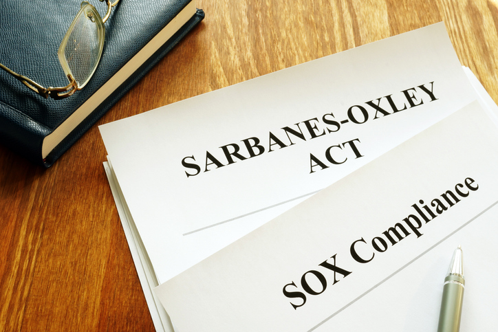 Professional nonprofit board meeting discussing Sarbanes-Oxley compliance