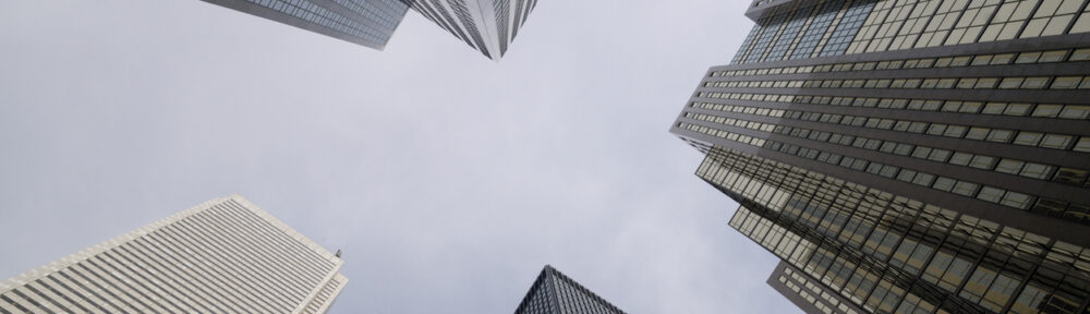 View from the ground looking up at skyscrapers - CPA 2025 Requirements by State | CPA Exam and Accountant Education